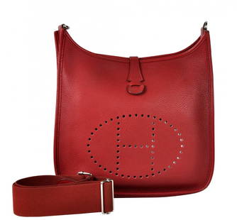 Hermes Rouge Red 'Evelyne PM' Leather Bag: Hermes 'Evelyne PM' is rouge (a lovely cherry red) leather. Features the iconic perforated H on the front, a snap closure and adjustable textile strap. The hardware is shiny palladium. Blind Stamp R i