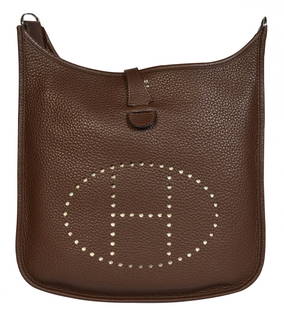 Hermes Cleamence Leather 'Evelyne PM' Bag 2014: Hermes Evelyne PM in chocolate brown clemence leather. This bag features a perforated H on the front, a snap closure and adjustable textile strap. The hardware is shinny palladium. Blind Stamp R in a