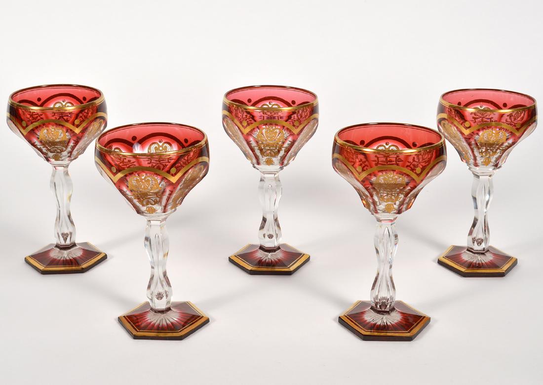 Five (5) Antique Baccarat Empire Ruby Wine Glasses: Rare ruby colored Baccarat wine glasses. Five glasses in the empire pattern. Not marked. 6" High. Wear to gilt with some minor fleabites, but overall good condition based on age. Examine all photos cl