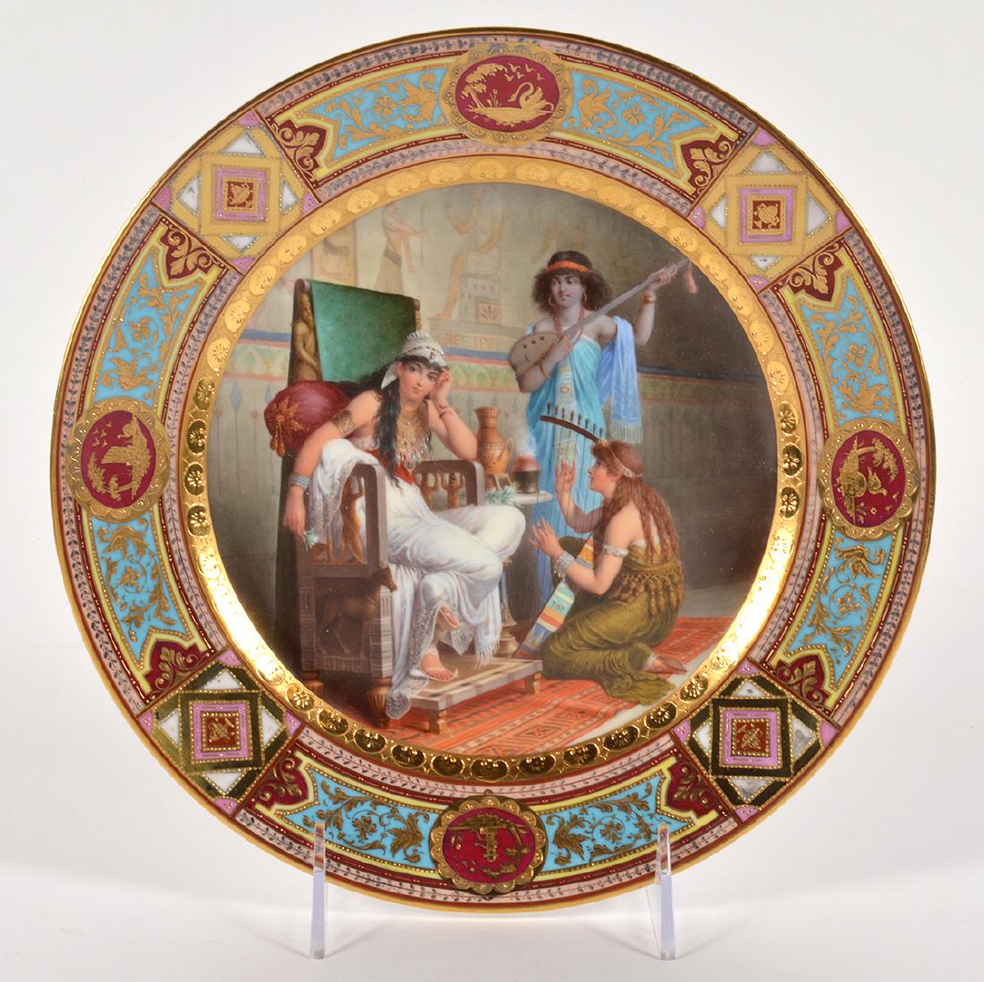 19th Ct. Hand Painted Royal Vienna Plate: Royal Vienna cabinet plate. Features 2 women playing musical instruments around another women in throne. Wonderful detail with beautiful gilt border. Marked on the back. Very good condition. 9.5" Wide