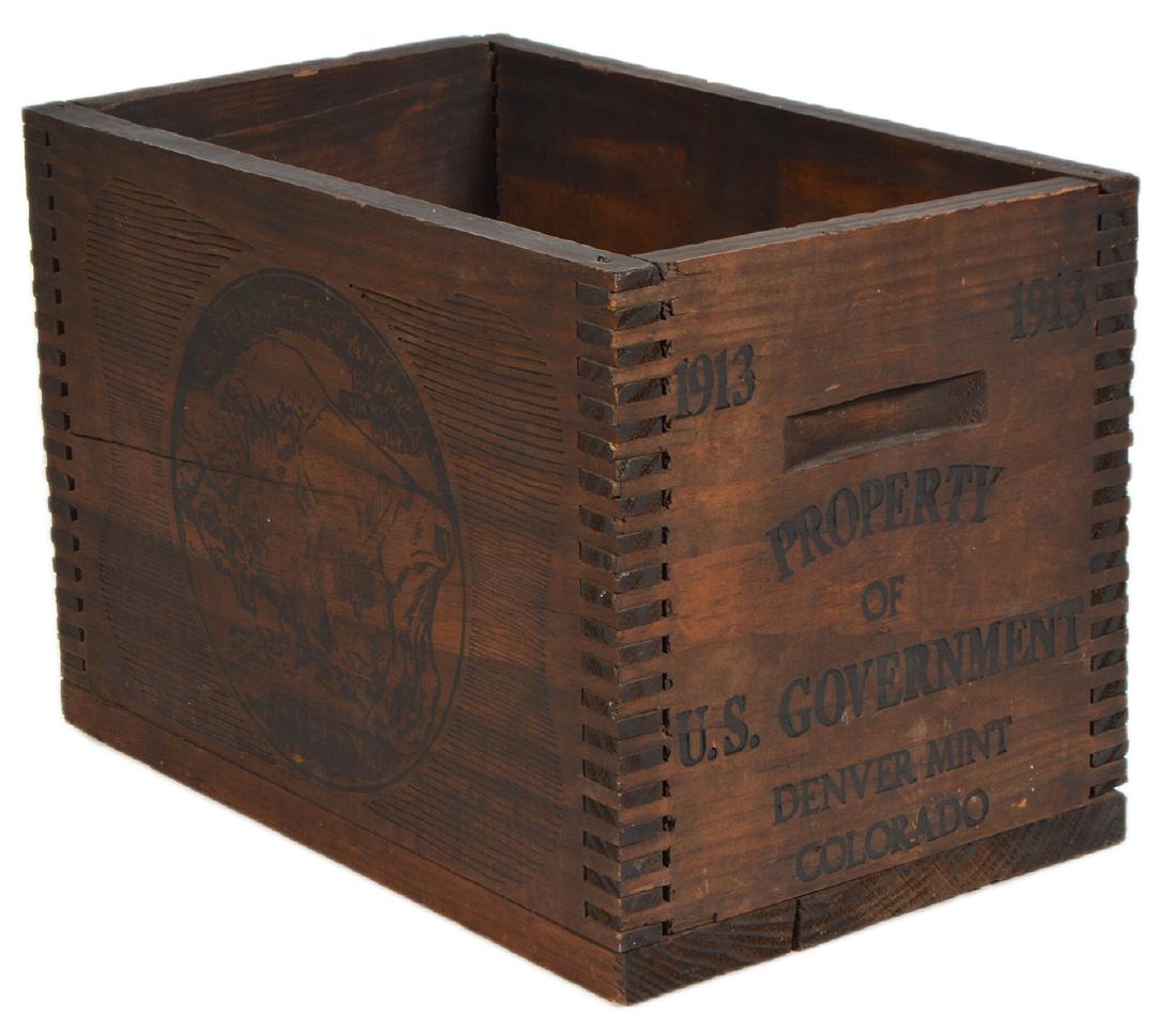 Buffalo Nickel Wood Crate: Single plank hard wood crate embossed on ends 'Property of U.S. Government Colorado 1913'. Renderings of Buffalo on the side 8" diameter; Two Gun White Calf on the other side, integrated groove handle