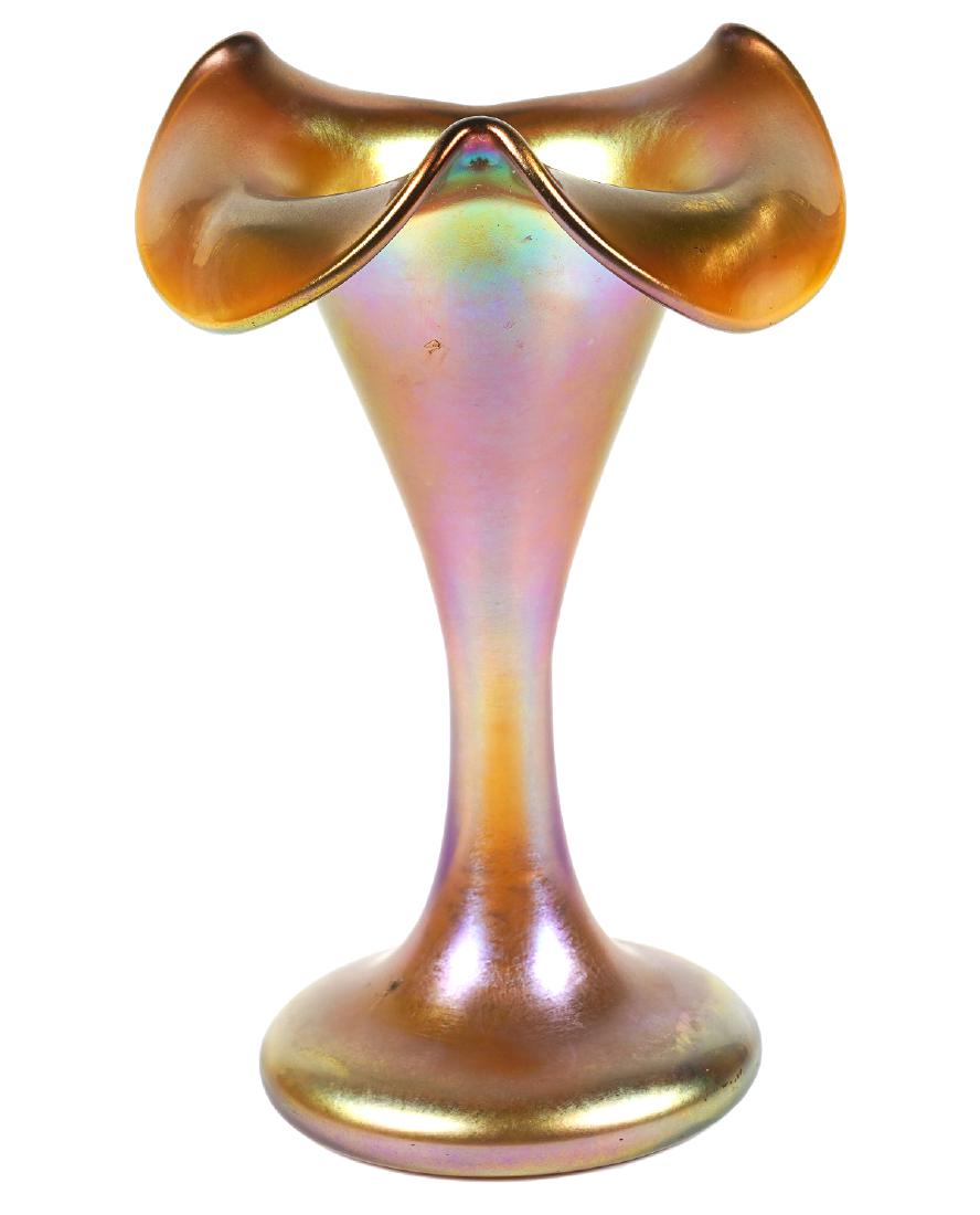 Quezal Gold Iridescent Trumpet Vase: Quezal signed trumpet vase in gold iridescent glass. Fluted top with wavy rim. Measures 5"H x 3 1/8"W. Good condition, see photos. Examine all photos closely. Contact AAG for more detailed information