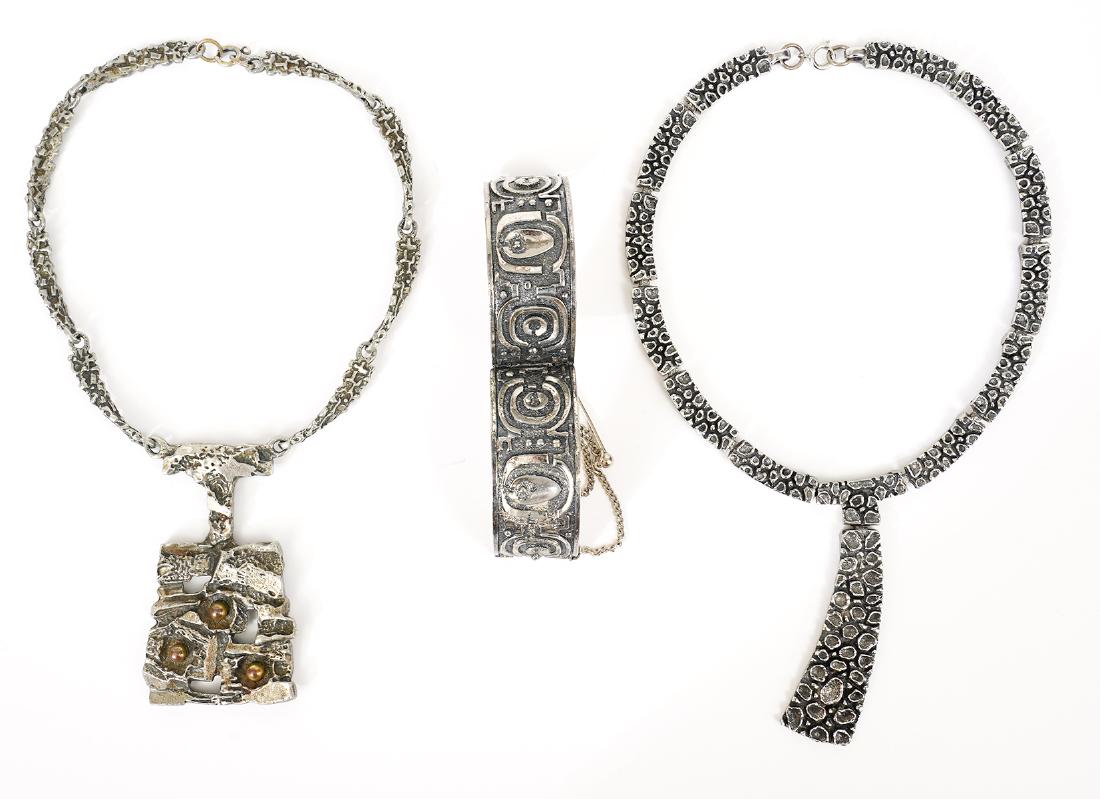 3 Pcs. Assorted Robert Larin Jewelry: Robert Larin choker style fashion necklace; abstract cuff bracelet with pin closure; large brutalist pendant with brass spheres, suspended on sectional chain. Good condition, see photos. Examine all p