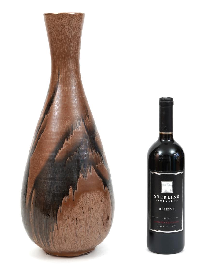 Blue Mountain Pottery Vase By Domenic Stanzione: Blue Mountain Pottery vase by Domenic Stanzione. Mocha colored and signed on the bottom. 19" High. Very Good condition. Examine all photos closely. Contact AAG for more detailed information if needed.