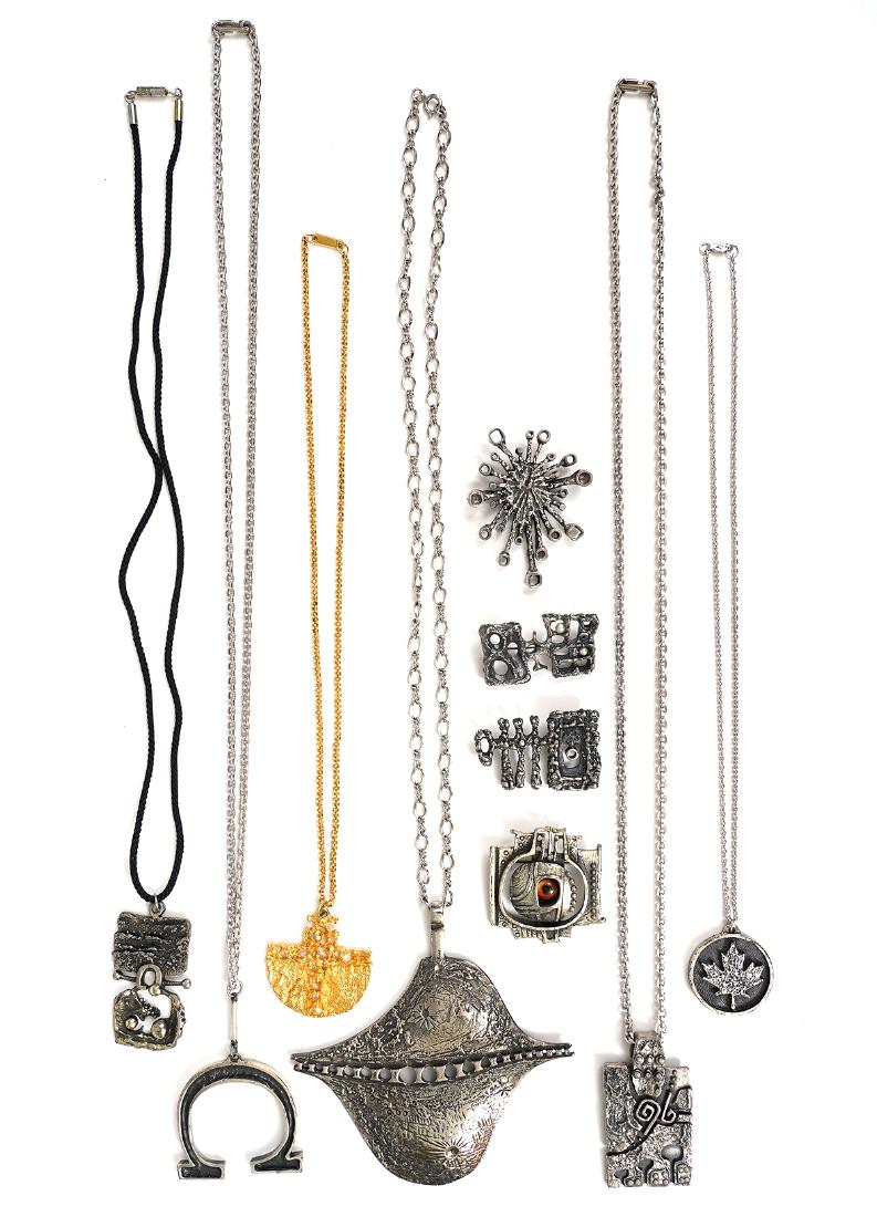 10 Pc. Guy Vidal Pendants & Pins: Guy Vidal pendants (6) include Canadian maple leaf, horse shoe, gold tone 'Ark' & 3 brutalist designs on chains (one unsigned). 4 Guy Vidal pins include vintage 'Eye', silver abstract pin with pearls 