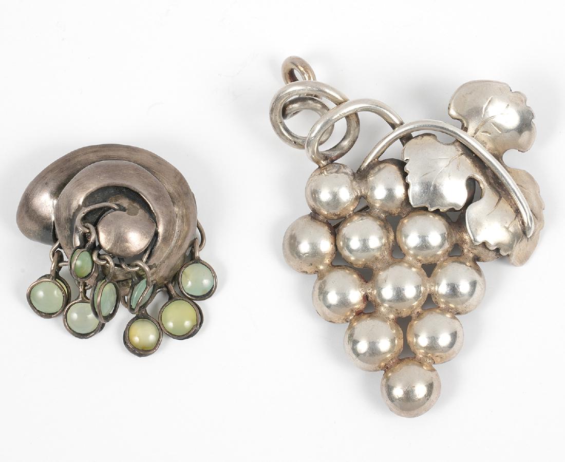 2 Nancy Meek Sterling Pendants: Nancy Meek sterling brooch in the form of a bunch of grapes, signed on back. measures 3"L x 2"W. Good condition, see photos. Sterling and moonstone brooch with 8 dangling moonstones, signed on back. M