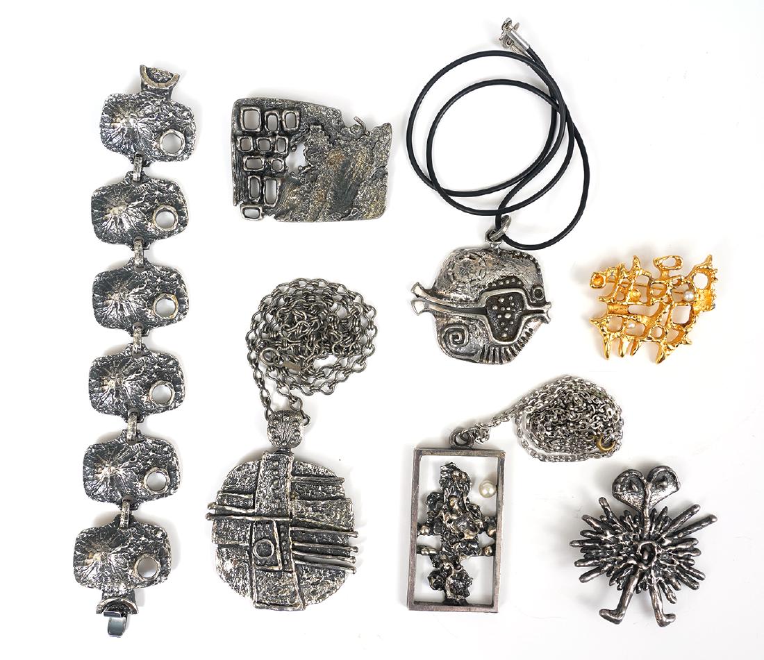 7 Pc. Guy Vidal Assortment: Guy Vidal pieces includes 3 modernists pendants, 3 pins and 1 bracelet. Good condition, one loose pearl in gold pin, see photos. Examine all photos closely. Contact AAG for more detailed information i