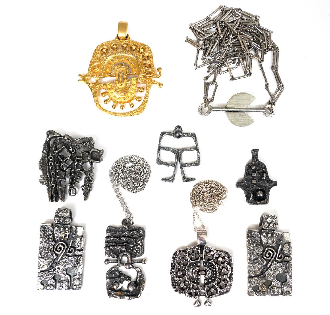 9 Pc. Guy Vidal Pendants & Pins: Guy Vidal silver tone pendant/pin on a chain, 7 brutalist pendants, one is gold tone, (2 with chains) and one modernist pin, signed. Good condition, see photos. Examine all photos closely. Contact AAG