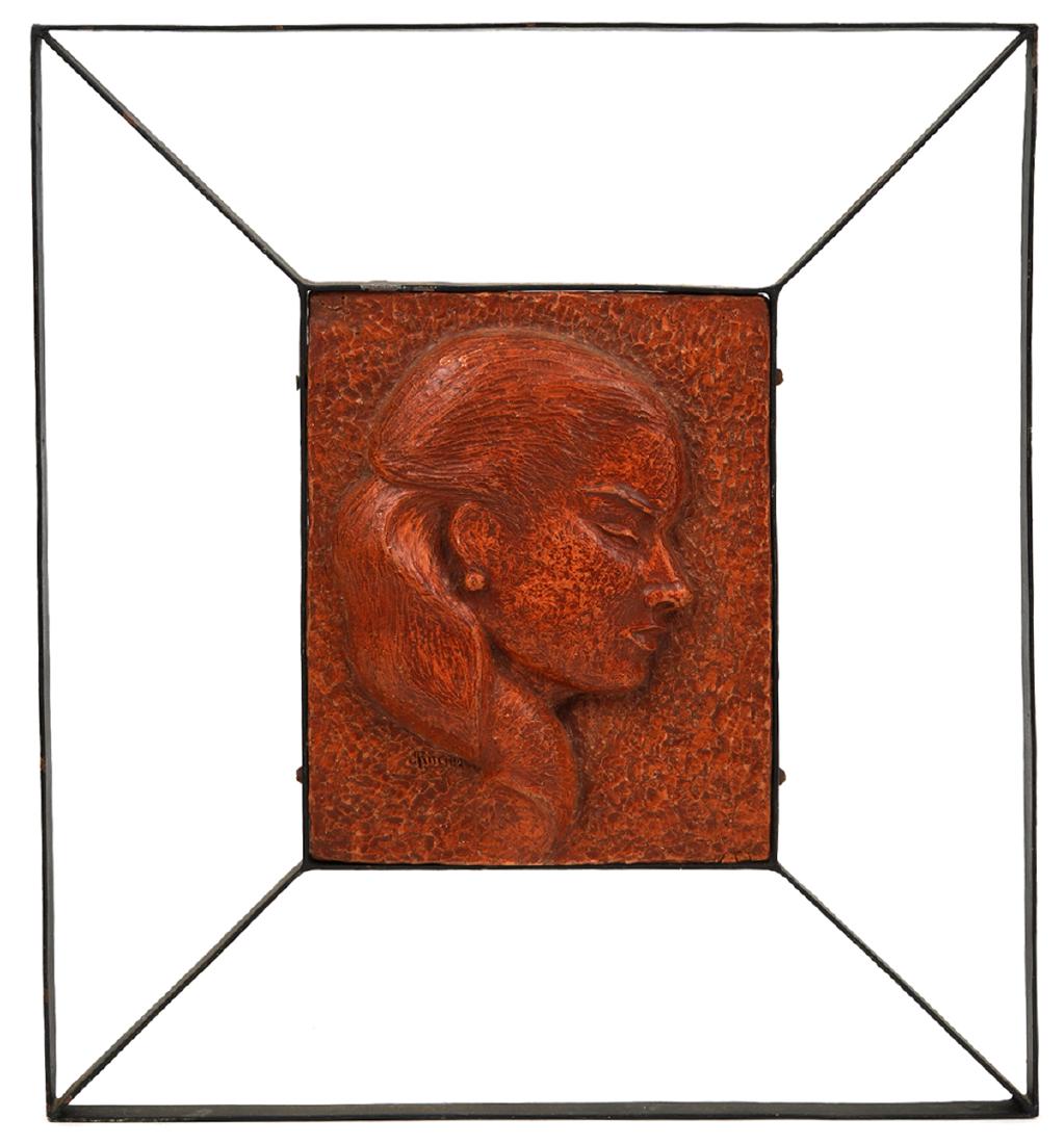 James Edward Ritchie Framed Ceramic Plaque: James Edward Ritchie, Quebec (1928-) Framed ceramic plaque of profile of a female, signed lower left. Mounted in open work iron frame, 'Ceramic Studio, 1544 Stanley St. No 12, F.H. 1953 J. E. Ritchie'
