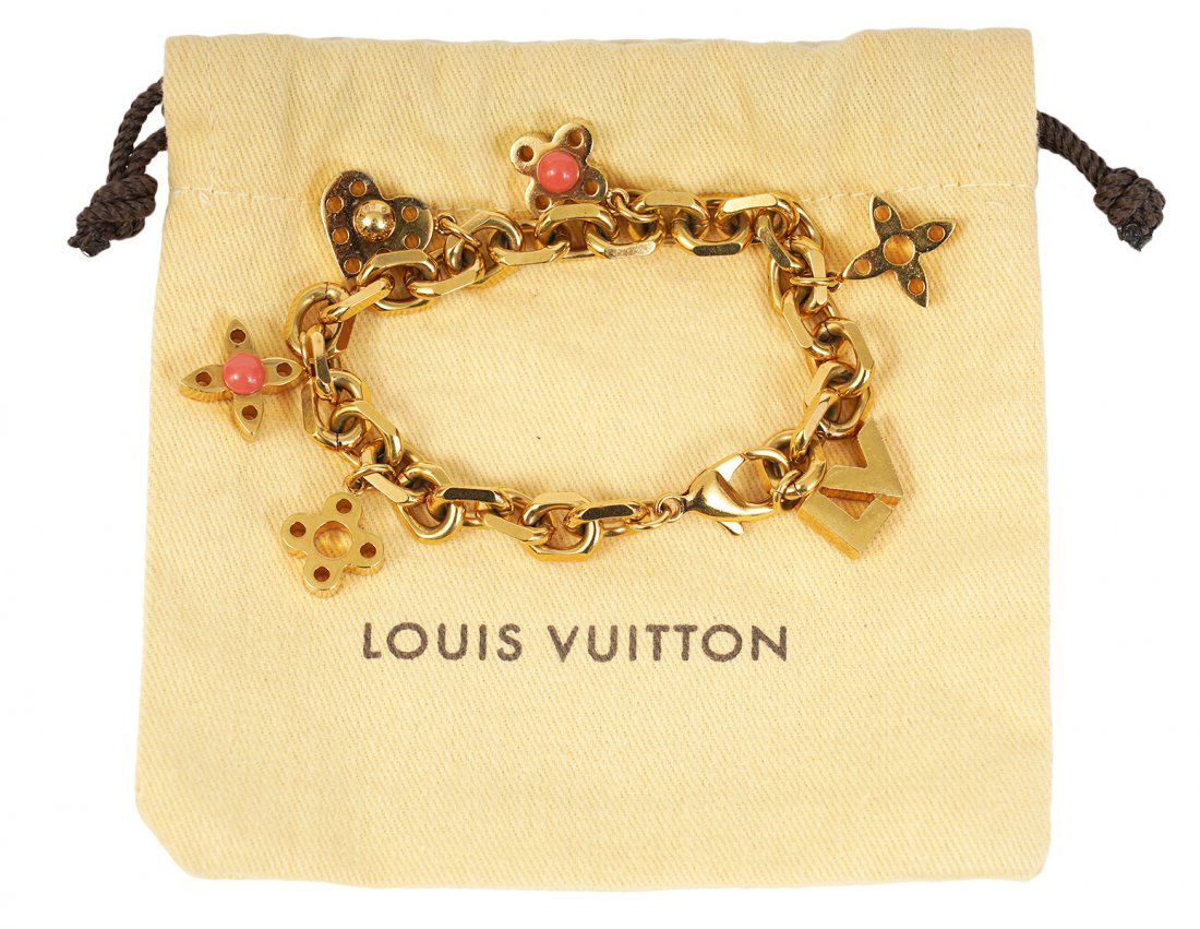 Louis Vuitton Monogram Charm Bracelet: Louis Vuitton gold plated playful "hide & seek" charm bracelet features 6 charms in iconic monogram styles. Lobster claw closure, marked LE1111, includes original pouch and box. Measures 7.5"L. Condit
