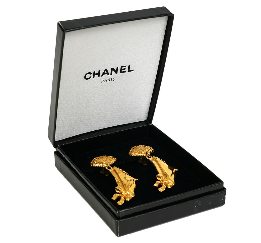 Chanel Coco's Beret Gold Tone Earrings: Chanel earrings in gold tone with dangling Coco Beret, 1980's. Clip on earrings, comes with Chanel box. Marked Chanel, Made in France. Measures 2.5"L. Condition report: good condition, see photos. Exa