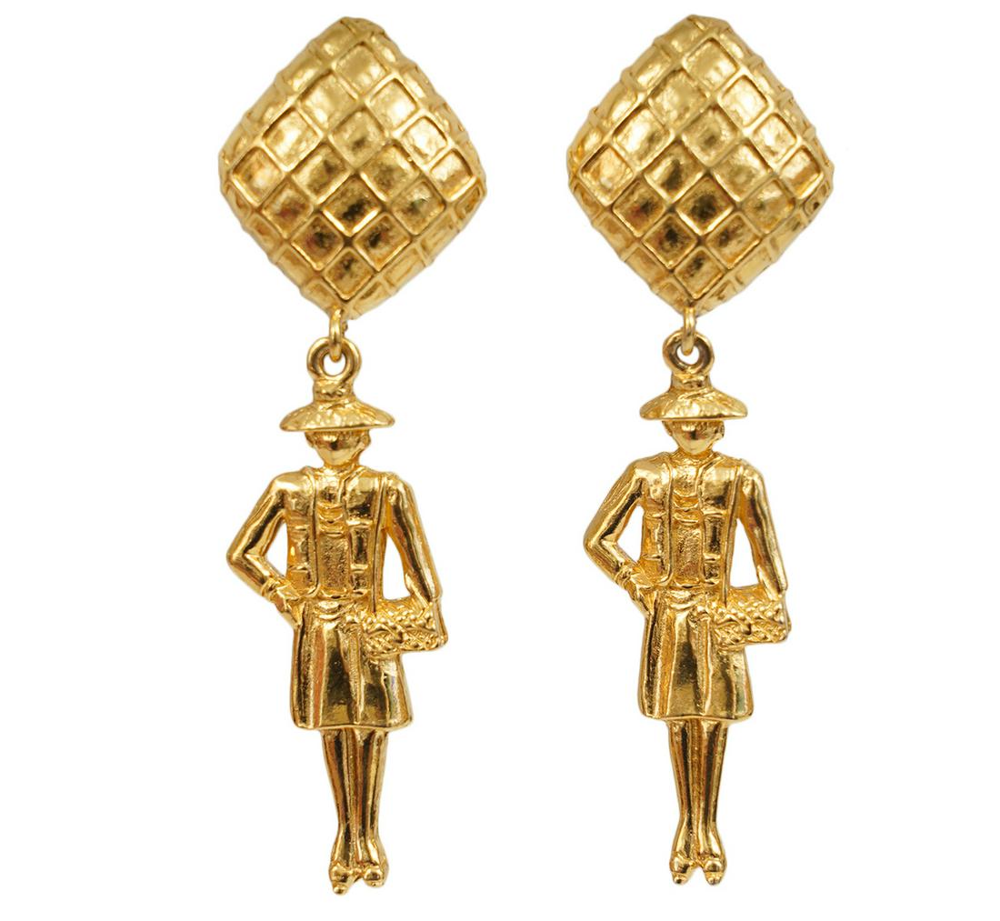 Chanel Gold Coco Dangle Vintage 1970's Earrings: These special gold tone earrings are Coco Chanel herself. She is carrying the iconic 2.55 bag and wearing her classic suit and hat. Vintage 1970's clip on earrings, marked Chanel, Made in France. Come