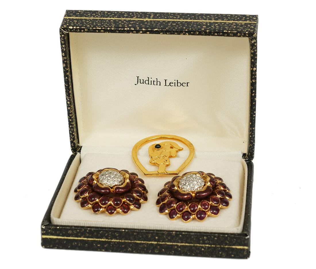 Judith Leiber Enameled Earrings & Gold Book Mark: Judith Leiber aubergine enameled flower shaped clip earrings in gold tone settings with crystal centers, marked on back. Measures 1 3/8" x 1 3/8"and comes in original box. Gold tone bookmark with embe