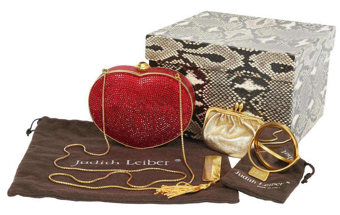 Judith Leiber Swarovski Red Minaudiere Heart: Judith Leiber vintage Valentine red Swarovski crystal heart shaped bag with gold trim and interior. Has 38"L gold chain shoulder strap that can be used or stored inside so the purse can be used as a c