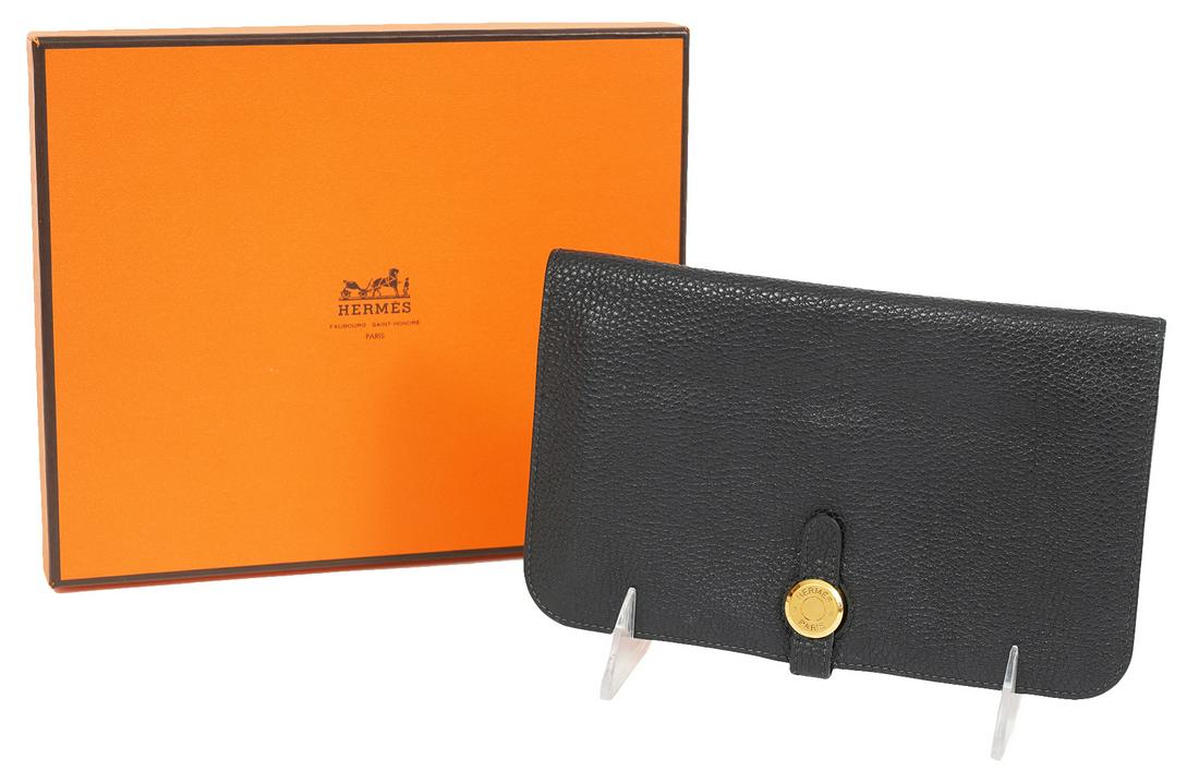 Hermes Black Dogon Togo Leather Wallet: Hermes black in Togo leather with gold tone Hermes buckle. There are 2 large and 2 small inside pockets. Comes with separate zippered change purse and original box. Blind stamp 'F' in square, 2002. Me