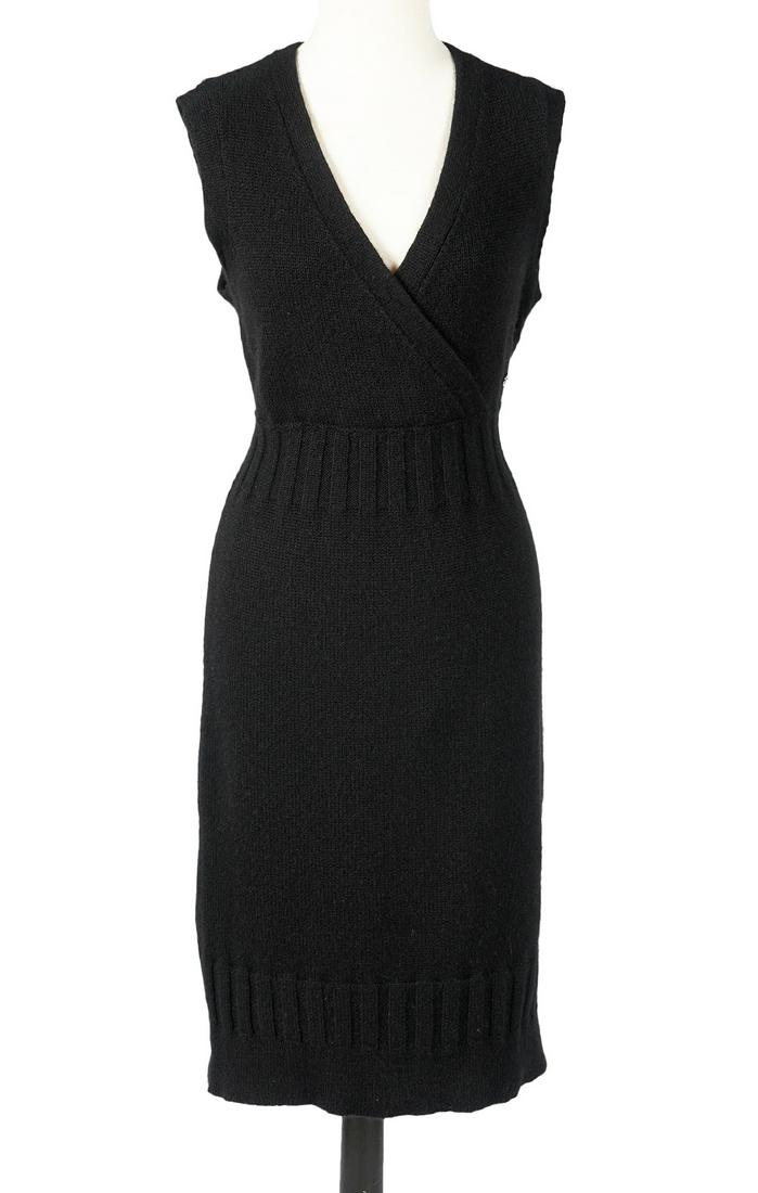 Chanel Cashmere Sweater Dress Sz 40: Chanel 2007 cashmere little black sweater dress with ribbed waist and trim and enamel oval Chanel medallion. Comes with flocked Chanel CC hanger. Measures bust 38"; waist 32"; hip 38"; length from sho