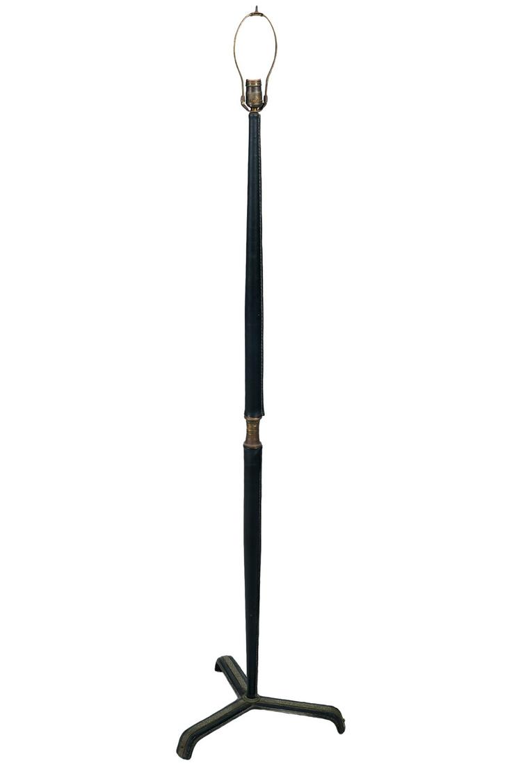 Jacques Adnet Stitched Leather Floor Lamp: Jacques Adnet, France (1901-1984) Tripod stitched leather and brass floor lamp with single socket. Measures 65.5"H to top of finial; 54.75"H tube shaft; tripod legs 16" x 16" x 16". Condition report: