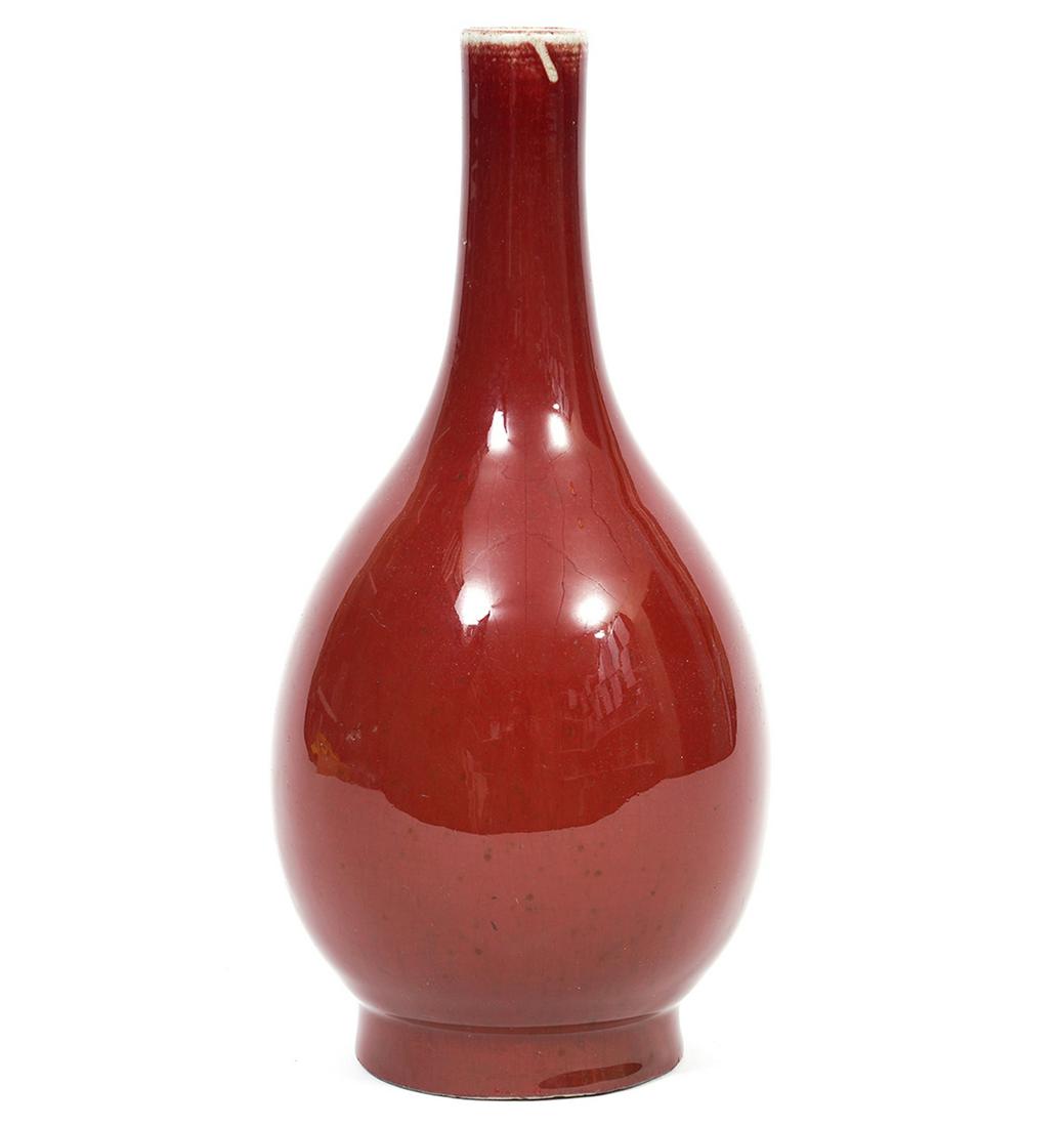 Chinese Oxblood Gourd Shaped Vase: Chinese oxblood gourd shaped vase with long neck, double blue ring on base. Measures 9.5"H x 4"W x 3" base. Condition report: good condition overall, some rough edges on rim of base, see photos. Exami