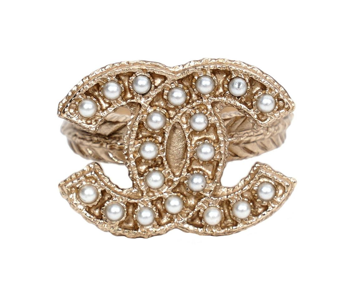 Chanel CC & Faux Seed Pearl Ring 2014 Size 5.5: Chanel ring in textured gold tone featuring a CC lined in tiny faux seed pearls. A14 S, 2014. Made in France. Size 5.5. Condition grade: 1. Examine all photos closely. Made in Italy. Contact AAG for m