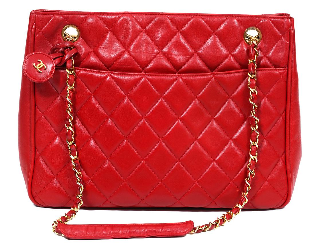 Chanel Vintage Red Lambskin Tote Shoulder Bag 1994: Chanel vintage red Lambkin tote shoulder bag featuring 2 outer slip pockets, 2 snap closures, polished gold tone hardware and leather laced chain straps with leather comfort sections. 11.25"L x 8.5"H