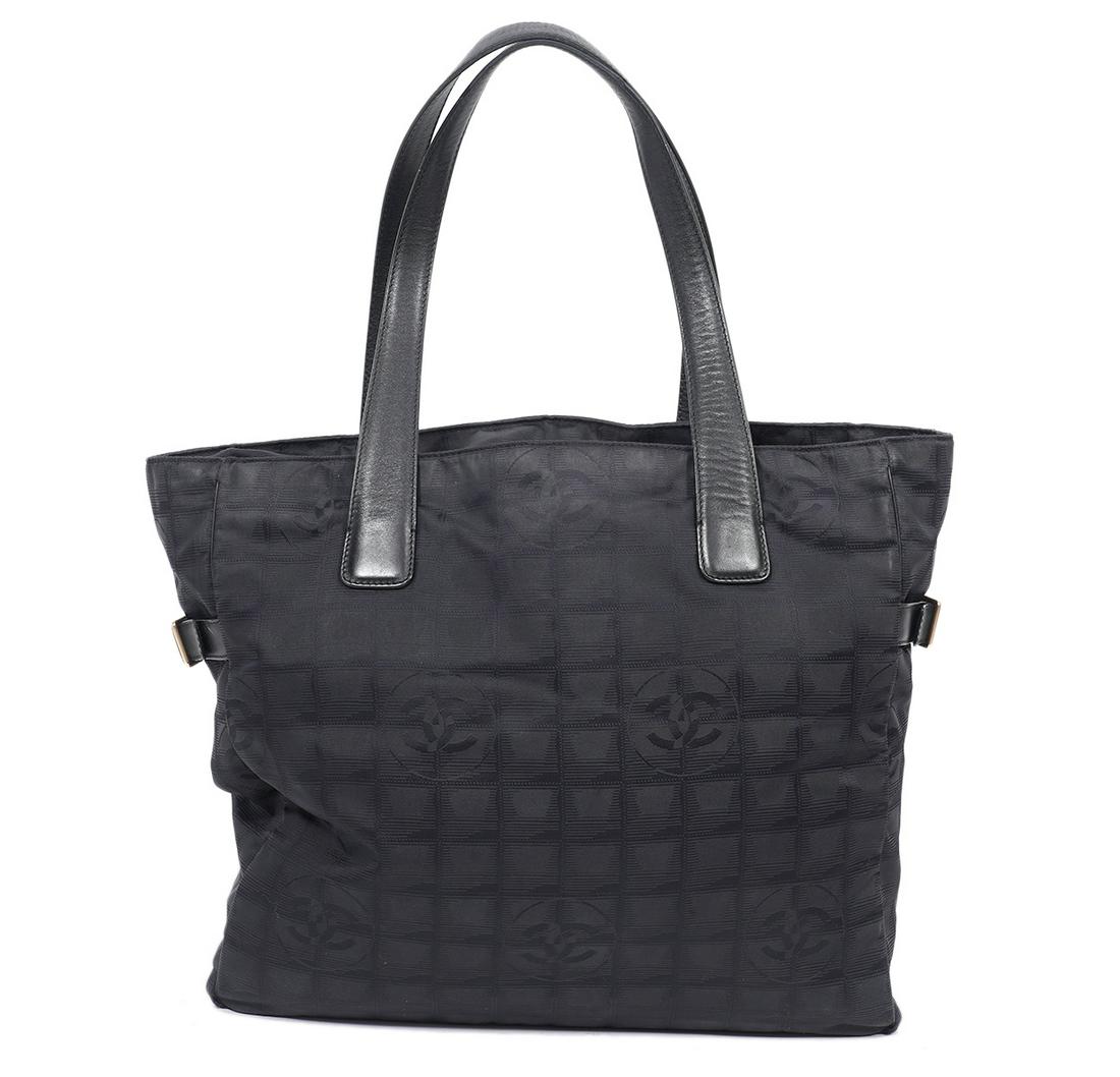 Chanel Black Travel Line Large Nylon Tote 2003: Chanel black signature nylon tote from the Travel Line featuring leather straps, silver hardware, a zipper closure and zipper pocket inside. 13.5"L x 12"H x 4.5"D. Strap drop 9". Made in Italy. Hologr