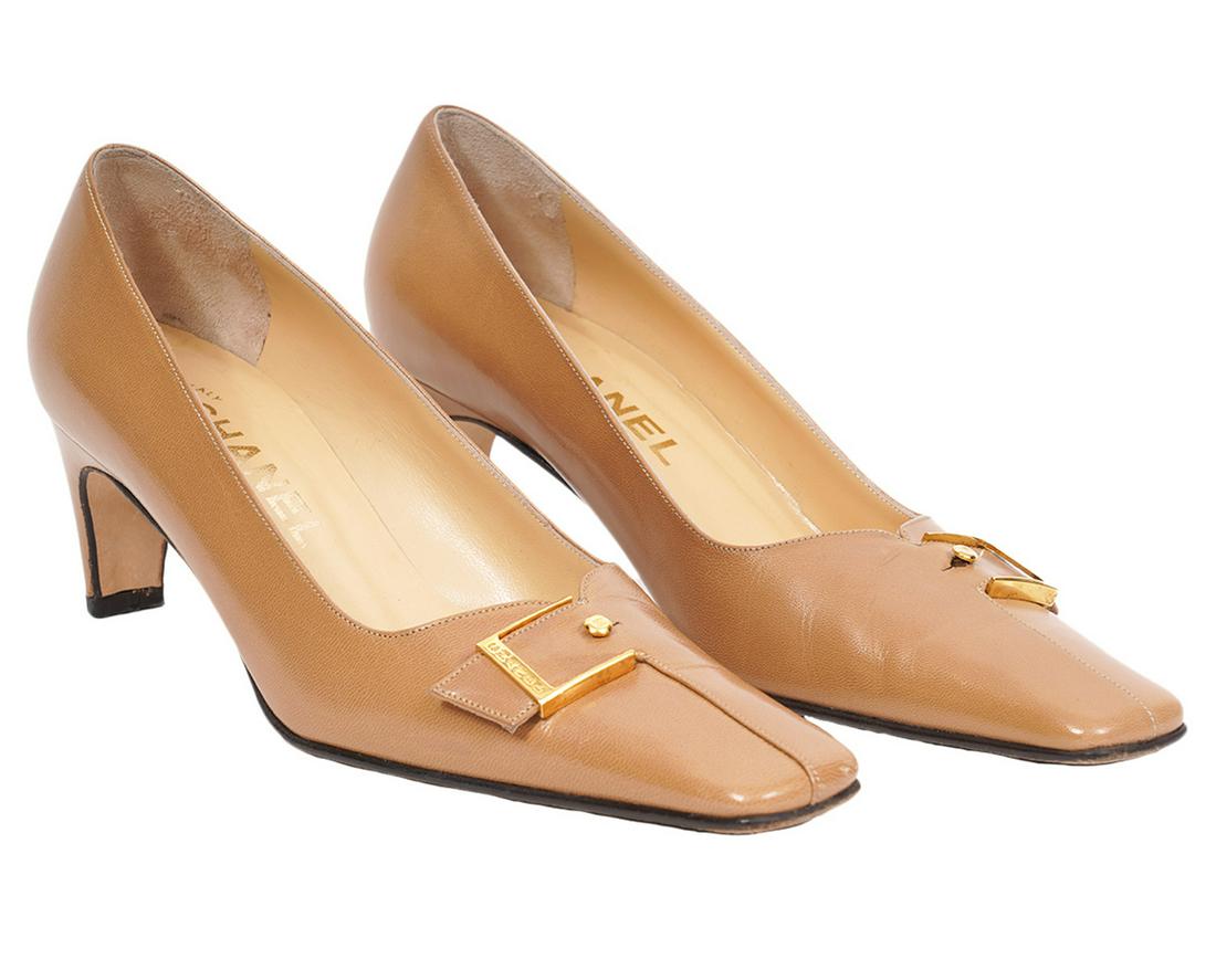 Chanel Vintage Beige Pumps Size 36 B: Chanel vintage beige pumps with a squared off toe, gold tone buckles embossed "CHANEL" and a tiny gold tone stud with an embossed CC. Heel height 2.25". Size 36 B. Date: 2001 A. Includes original box.