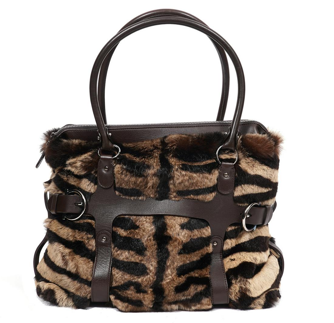 Salvatore Ferragamo Animal Print Fur Bag: Salvatore Ferragamo soft luxurious rabbit fur bag with an animal print featuring brown leather bottom, accents, trim and rolled handles. Polished silver hardware and zipper closure. Lined in cream fab