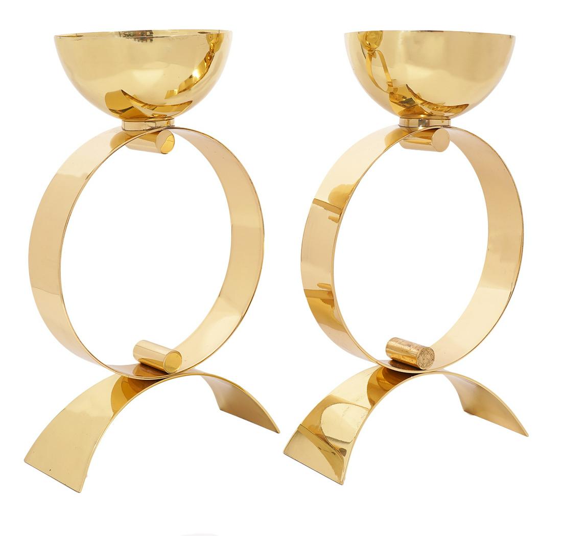 Pr. EG Cody Brass Sculptural Table Accessories: Pair of EG Cody brass sculptural accessories with center circular form, semi-circular base and bowl shaped top. Measures 16"H x 9 3/8"L x 3.75"W base. Condition report: good overall condition, one cir