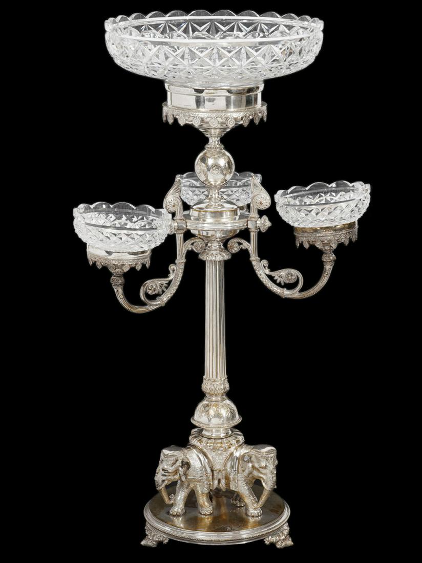 English Silverplate 'Elephant' Epergne: English silverplate 'Elephant' epergne with 1 large and 3 small cut glass bowls with scalloped rims. Base has 3 ornate elephants under a ribbed center column with 3 scrolled decorative arms holding 3 