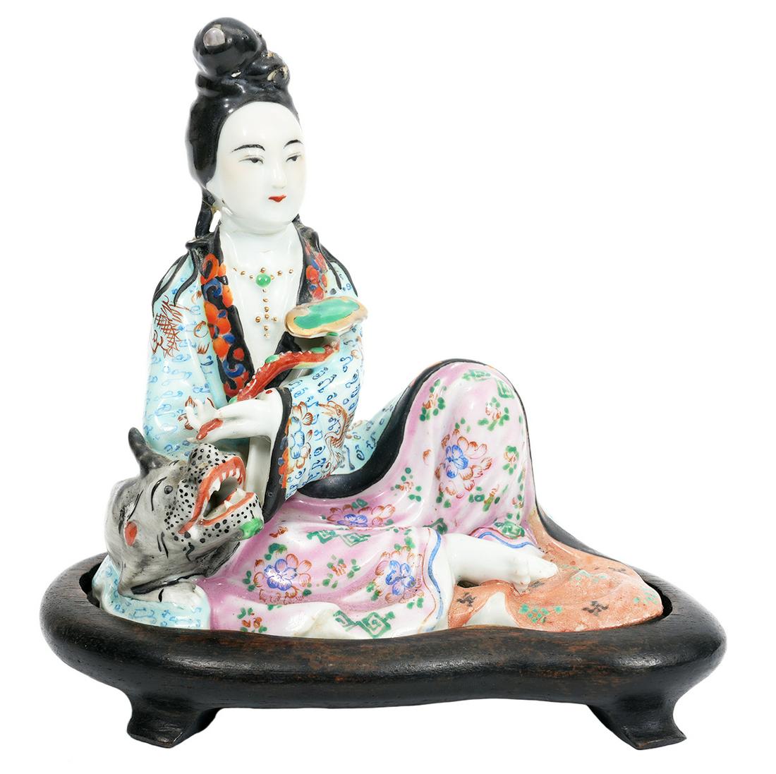 Chinese Porcelain Figure with Dragon on Plinth: Chinese porcelain seated figure of a woman in elegant robes with a small dragon at her side, nicely detailed, mounted on carved wood plinth. Chinese chop marks impressed on underside. Measures 5.25"H 