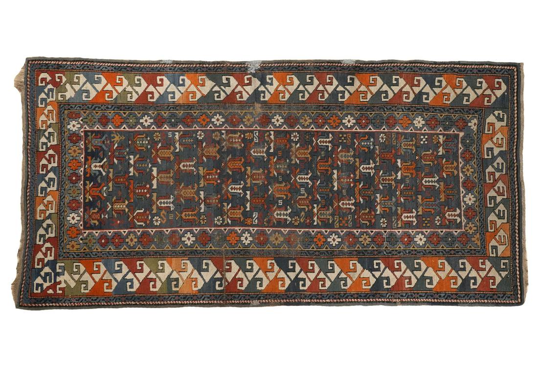 Antique Caucasian Rug: Antique Caucasian rug originating from the area of Caucasus, a mountain region bordering Persia and Turkey. Best known for their bold contrasting colors and shading techniques. Measures 73"L x 34.5"W.