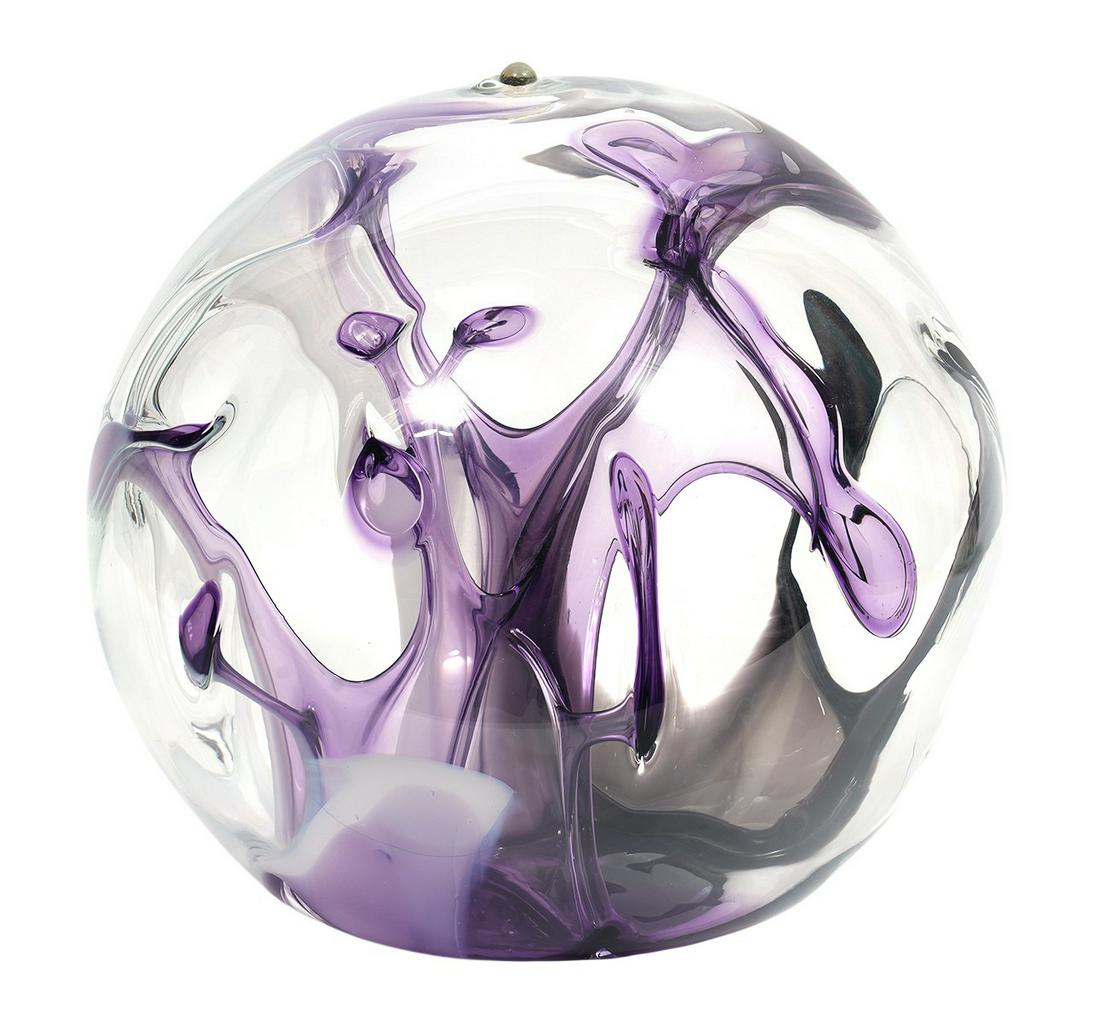 Large Peter Bramhall Hand Blown Glass Orb: Peter Bramhall, American (Born 1942). Large hand blown clear glass orb sculpture with interior striations and stems of color in purple, lilac and white. Signed and dated on bottom '27 November 1987'.