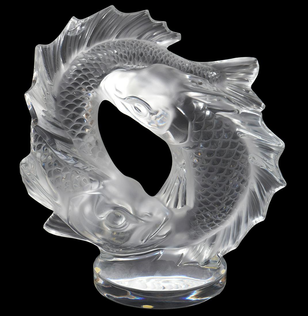 Lalique Deux Poisson Clear & Frosted Crystal: Lalique Deux Poisson clear and frosted crystal sculpture designed by Marc Lalique in 1953, two fish forming an endless circle, mounted on clear base etched with 'Lalique France'. Measures 11"H x 11"L 