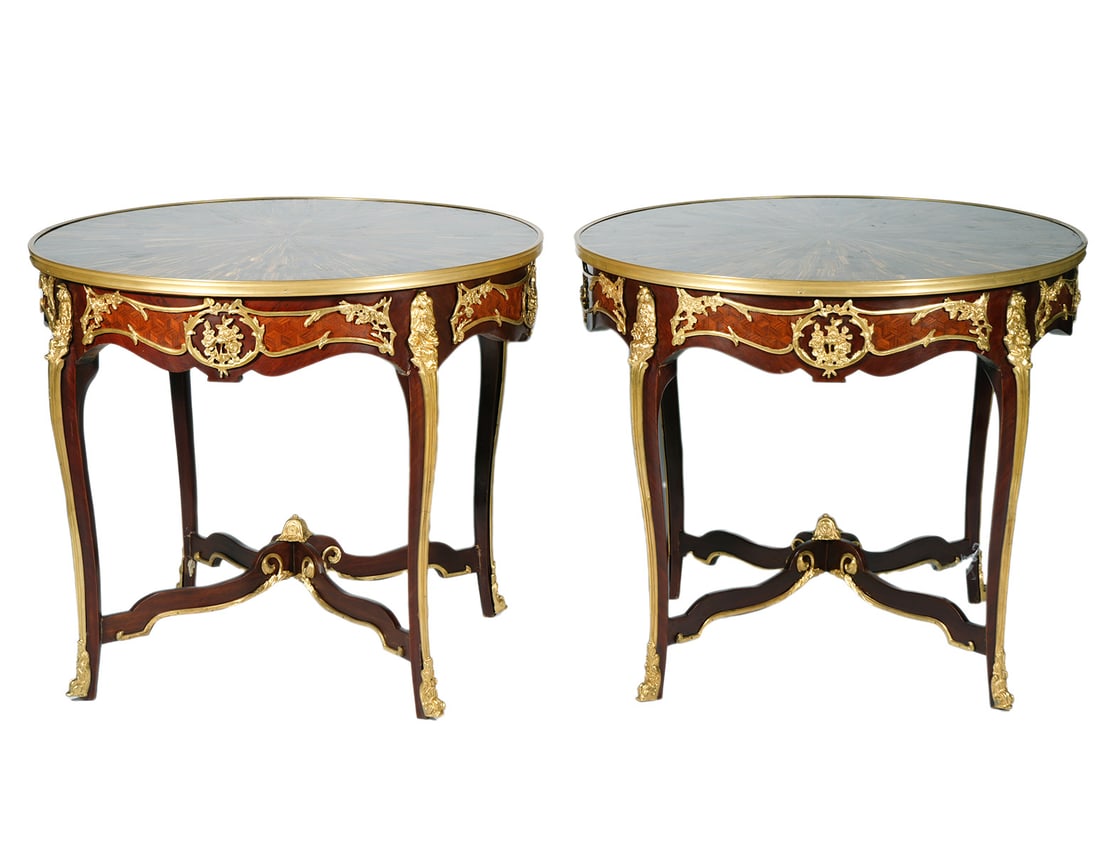 Pr Louis XV Style Bronze Mounted Gueridon Tables: Pair of French Louis XV style gilt bronze mounted gueridon tables with inlaid tiger eye stones, embellished with ornate bronze swags and sabot feet. Measures 30.5"H x 35.25"W. Condition: minor light s