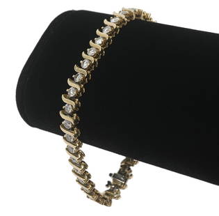 Diamond 'S' Link 14K YG Tennis Bracelet: Diamond 'S' link 14K yellow gold tennis bracelet contains 36 brilliant cut diamonds (I-J VS2-S1-1) prong set in an 'S' link design with a fold over safety latch. Approx. total weight 5.50cts, 7.5"L, w