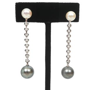 Cartier Signed Tahitian Pearl & 18K WG Earrings: Cartier signed Tahitian pearl and 18K white gold pierced dangle drop earrings stamped 'Cartier 750 2001AD4972' showcasing 2-7mm each cultured pearls at top connected with 3" open link chain. These are