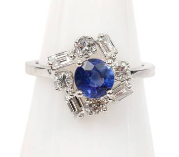 Lady's Natural Sapphire & Diamond 14K WG Ring: Lady's natural sapphire and diamond 14K white gold cluster ring features an approximate .50ct round natural prong set sapphire complemented by 8 brilliant and baguette cut diamonds (H-VS1-SI1) in a fr