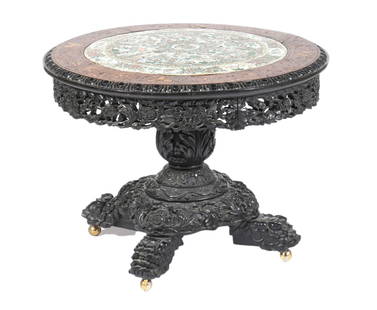 Chinese Hardwood Carved Porcelain Top Table: Chinese carved hardwood circular table with porcelain top in Famille Verte, style of Chinese porcelain, has a pedestal base supported by 4 inticately carved feet. Full frieze has carved foliate design