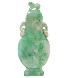 Chinese Baluster Green & White Jade Lidded Vase: Chinese baluster shaped green and white jade lidded vase with two animalistic ring handles, foo dog finial, incised floral designs on each side and Greek key pattern around top and bottom. Measures 4.