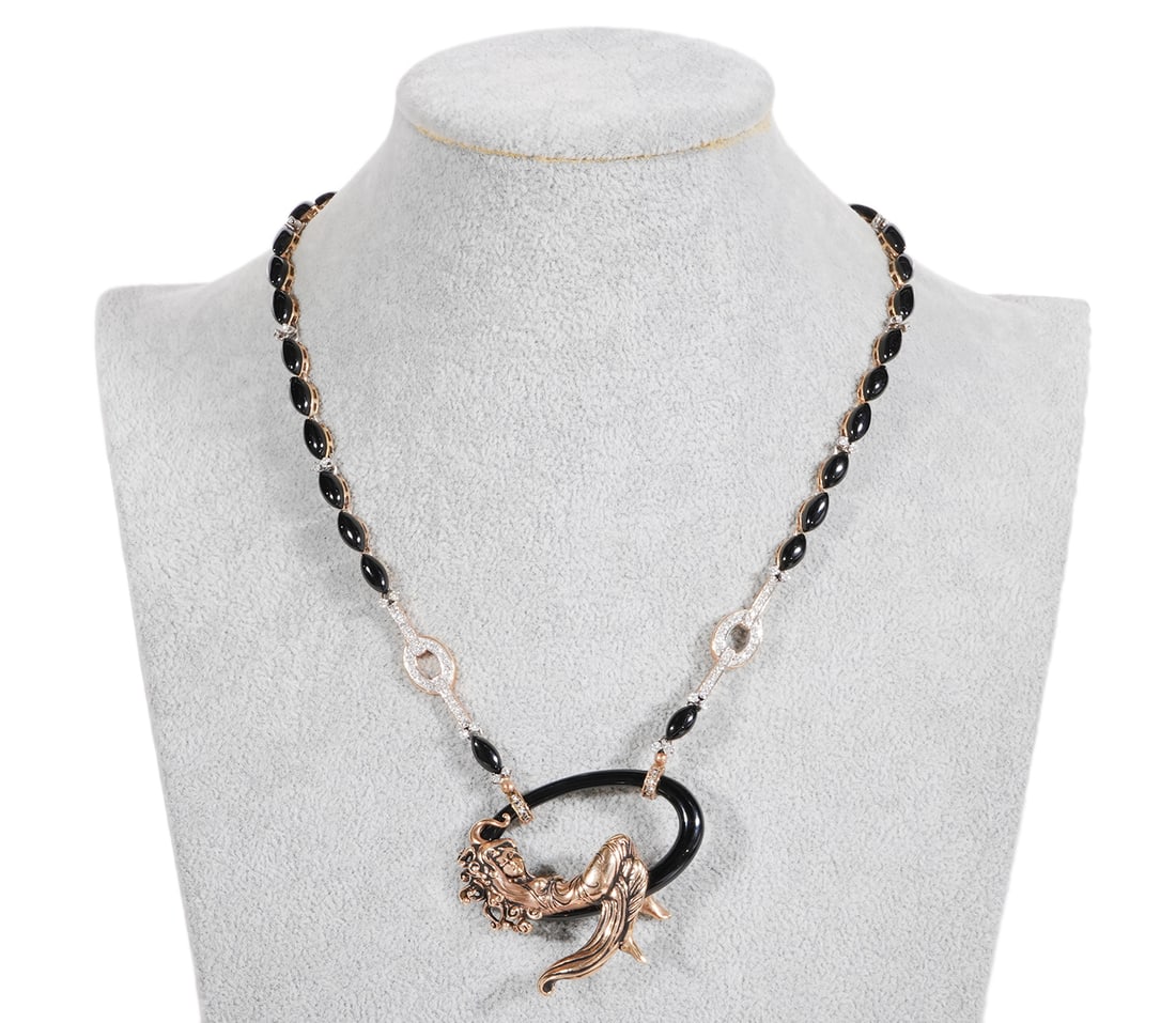 Erte 'Femme Endormie' CFA Necklace: Romain de Tirtoff, Russia/France (1892-1990). Erte 14K yellow gold, diamond and onyx 'Femme Endormie' necklace is signed 'CFA 14K' (Circle of Fine Arts). Pendant measures 1.75" x 2 1/8"; necklace 18"L