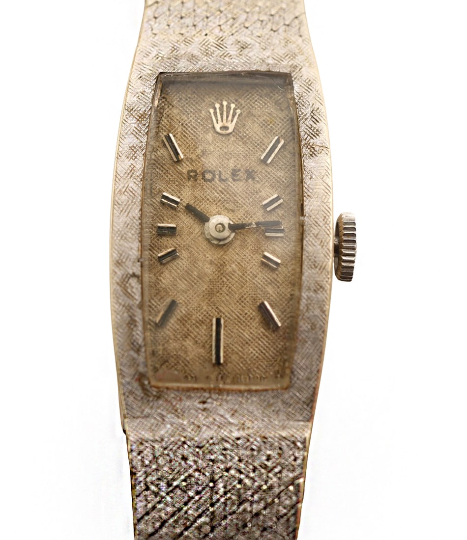 Rolex 14K White Gold Lady's Wristwatch: 14K white gold lady's dress Rolex wristwatch has a 14K white gold integral linen textured bracelet and 17 jewel manual wind movement signed 'Rolex'. The watch has a linen texture dial with applied bat