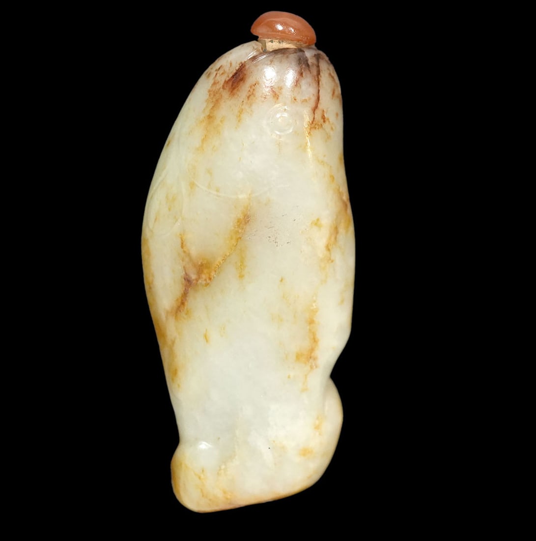 Chinese Jade Snuff Bottle Form of a Fish: Jade snuff bottle in the form of a fish has a cornelian colored lid and measures 4.5"L x 2"W x 7/8"D. Condition: good condition, no issues, please see all photos. Contact AAG for additional informatio