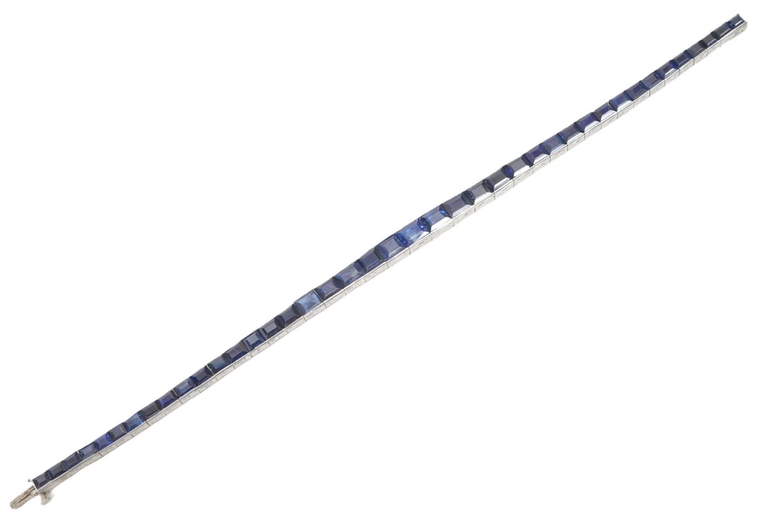 Art Deco Antique Sapphire & Platinum Bracelet: Art Deco antique natural sapphire and platinum graduated straight line bracelet featuring approx. 8-10cts. of natural French cut blue sapphires in a channel setting exhibiting vivid royal blues with f