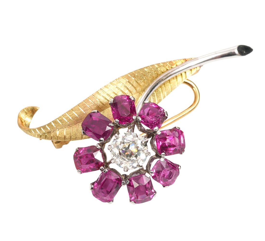 Diamond, Ruby & 18ct. Two Tone Floral Spray Brooch: Mid 20th century diamond, ruby and 18ct. 2 tone floral spray brooch showcasing a central approximate 1ct. old European cut diamond (H-I / VS2) surrounded by 8 natural beautifully matched high quality 