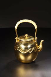 A CARVED GILT-SILVER TEAPOT AND COVER.ANTIQUE