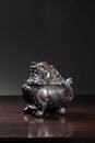 A CARVED ZITAN QILIN BURNER