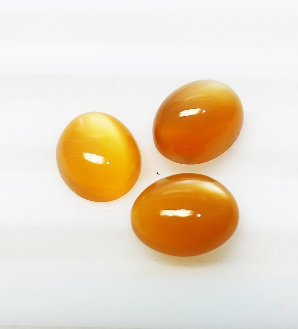 Moonstone - 7.75 ct. - Cabochon - Orange- 3 Pieces: Natural Cabochon Moonstone - 3 Pieces - 7.75 ct. , Color - Orange , Average Dimension - 8.2 x 6.2 (mm), Cabochon Cut Design with smooth surface , Origin - Africa , Good Quality With Luster.