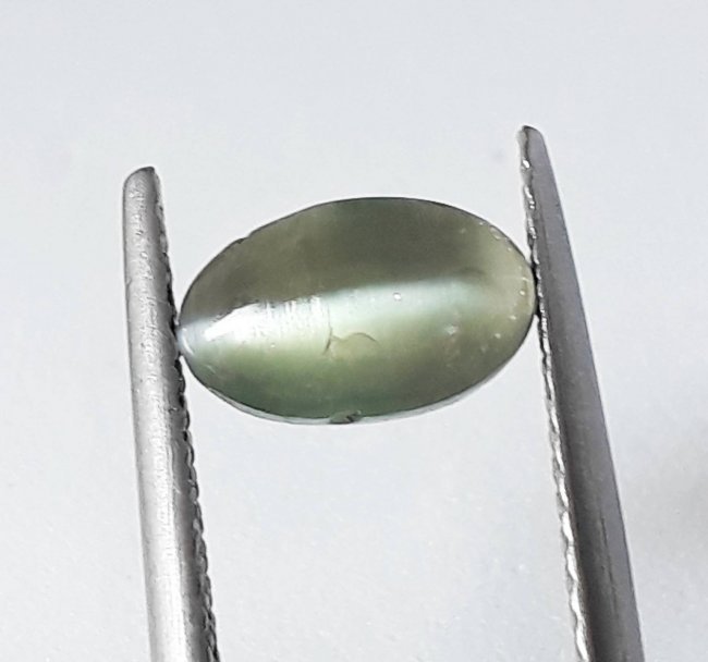 Natural Alexandrite Cat's Eye - 1.33 ct.: Natural Alexandrite Cat's Eye - 1.33 ct. , Color - Green , Shape - Cabochon Oval Cut, Dimension - 8.0 x 5.1 x 3.0 (mm) , Origin - Africa, Minimum Color Change, Good Quality With Luster.