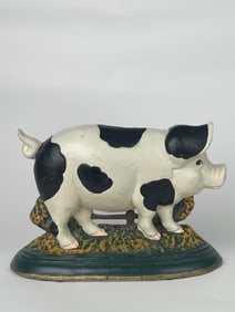 A Big Cow Print Cast Iron Pig Doorstop