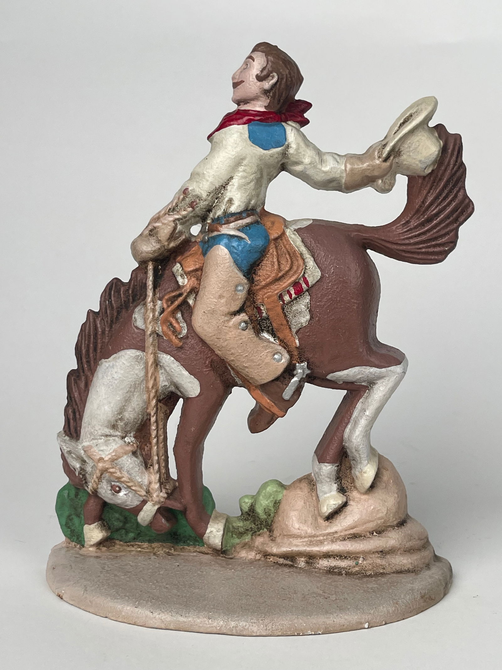 A Cast Iron Doorstop Figure of a Cowboy on a Horse: A Cast Iron Doorstop Figure of a Cowboy on a Horse. H:8-1/4” W:6-1/2”